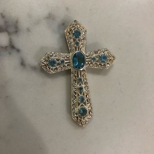 Blue topaz and sterling silver cross pendant.